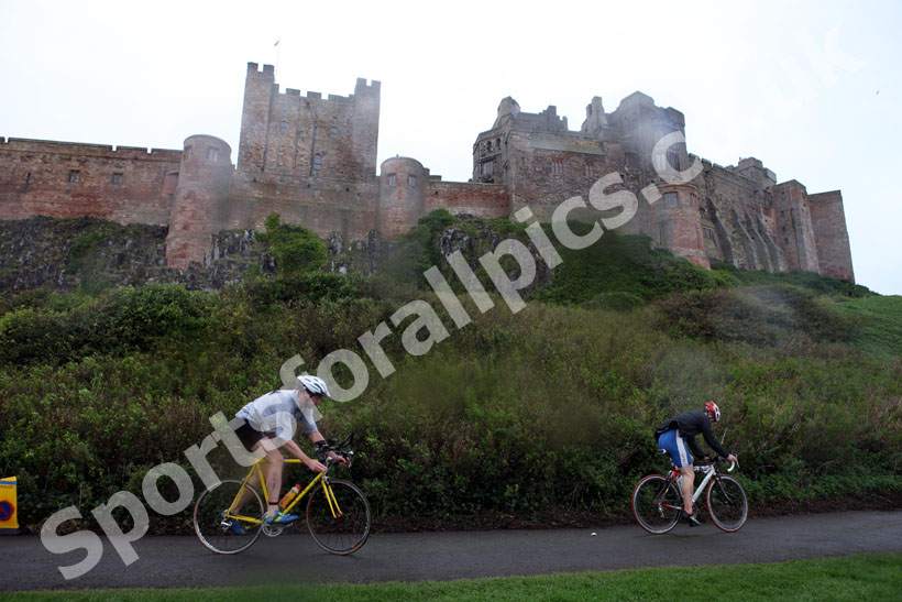Start of the cycling during the Bamburgh Triathlon with Bamburgh Castle as a backdrop with heavy rain falling